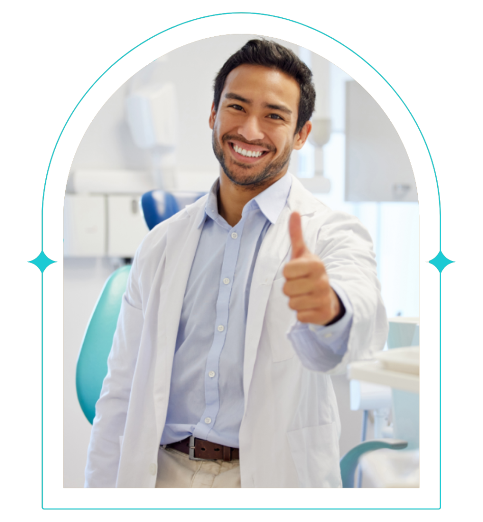A dentist from Clearly Dental Camden is posing with a thumbs up