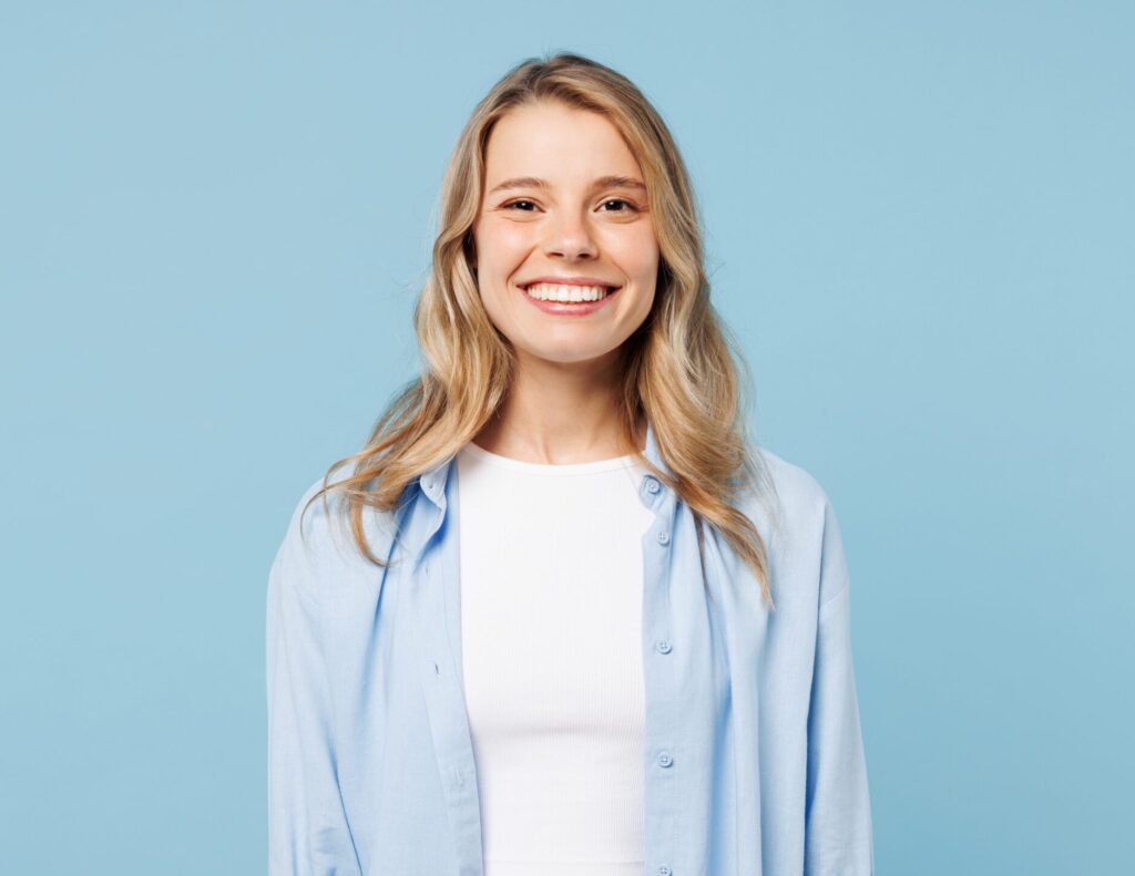 A blonde-haired female patient at Clearly Dental Camden shows her bright smile after receiving dental treatment
